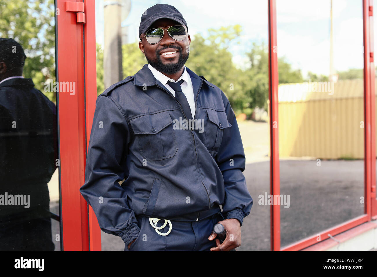 Black security professional monitoring CCTV